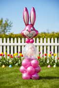 Pink Easter balloon bunny arrangement with outdoor garden background